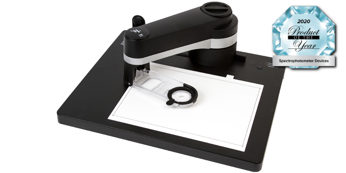 A black color scanner instrument being used on white paper.